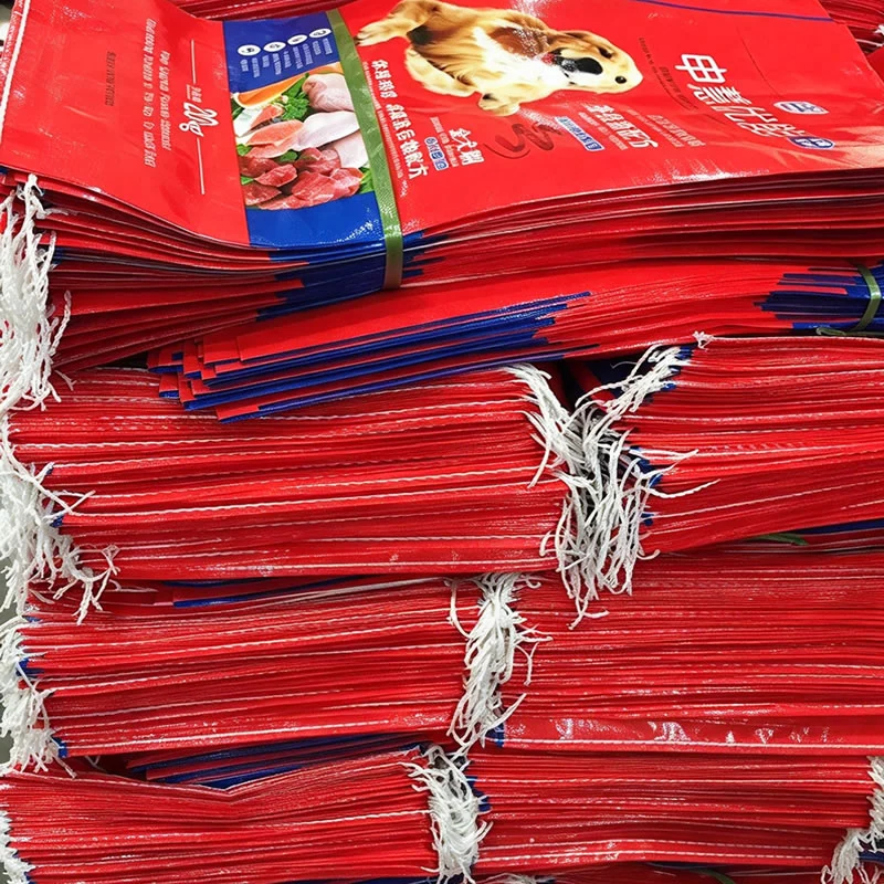 Bundles of red pet food printed woven bags stacked and tied for packing