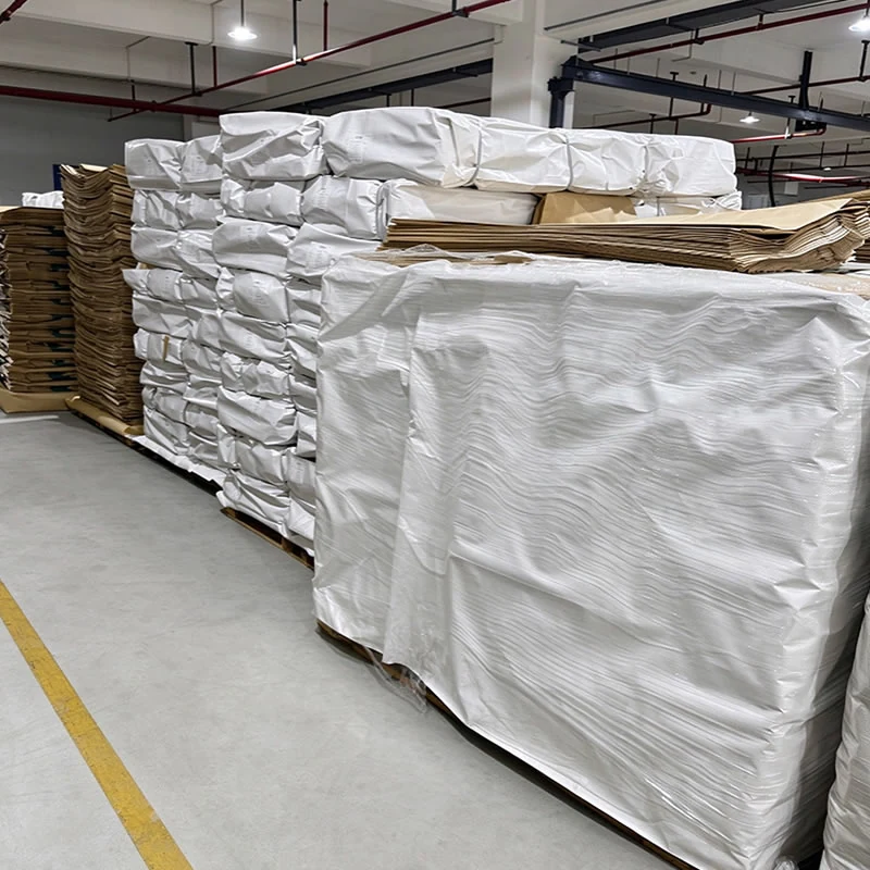 Palletized white and kraft paper bags shrink wrapped in the warehouse