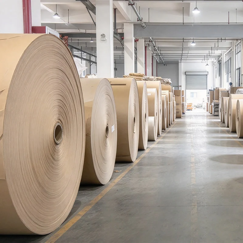 Corridor of kraft paper jumbo reels on the factory floor waiting for the tuber