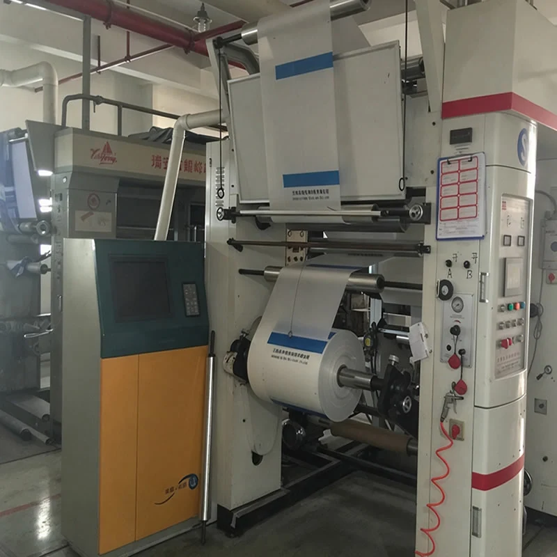 Rotogravure printing press with a printed PP web running through the rollers