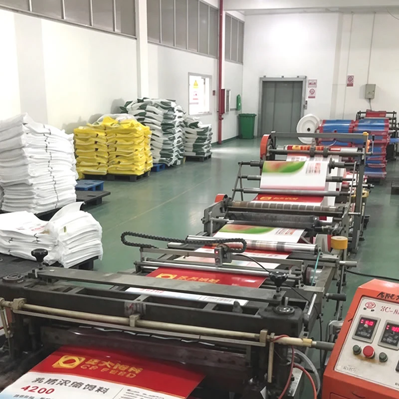 Bag converting line cutting and sewing printed PP woven sacks, bundled bags alongside